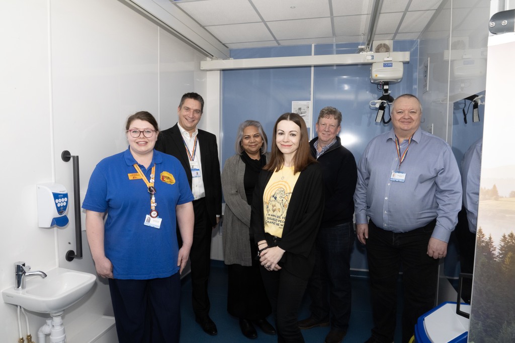A photo of several people involved in getting the changing places toilet installed, smiling for the photo in the facility.